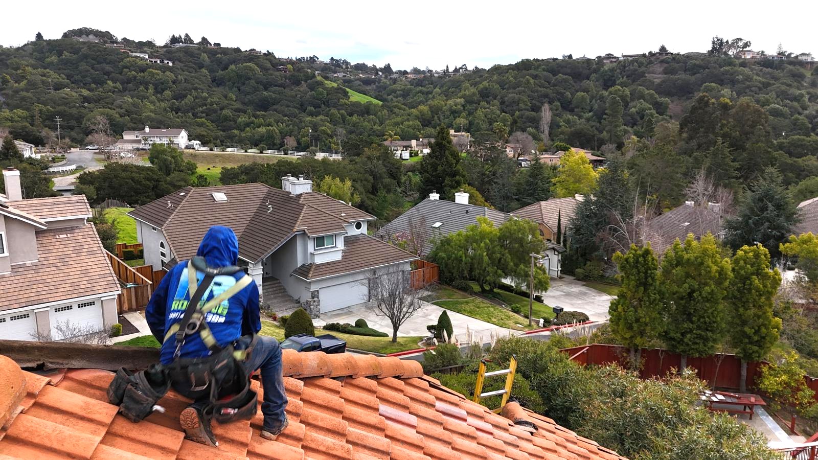 “R&R Roofing technician inspecting tile roof in Hayward, CA, a Bay Area residential neighborhood